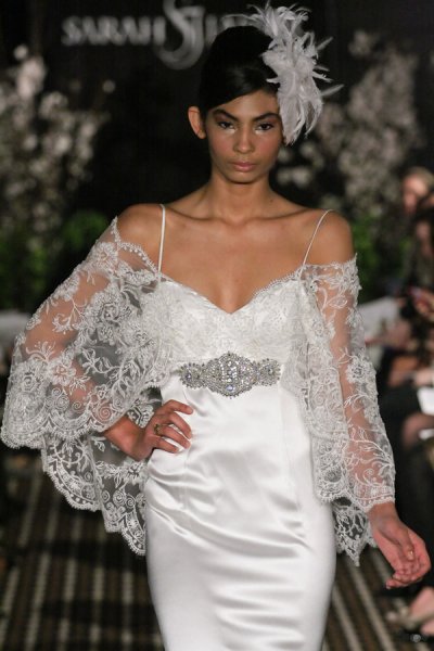 Model walks runway in a Serene wedding dress by Sarah Jassir, for the Sarah Jassir Fall 2011 - Desire bridal collection.