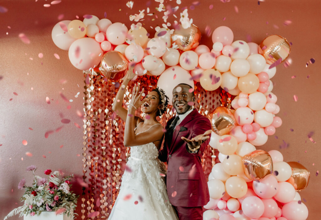 Bride and Groom throwing confetti in playful and romantic valentine's shoot.