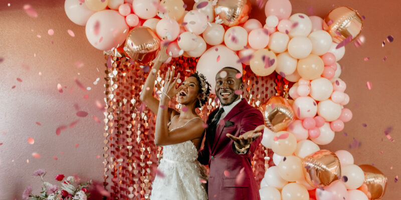 Bride and Groom throwing confetti in Valentine's Inspired shoot.