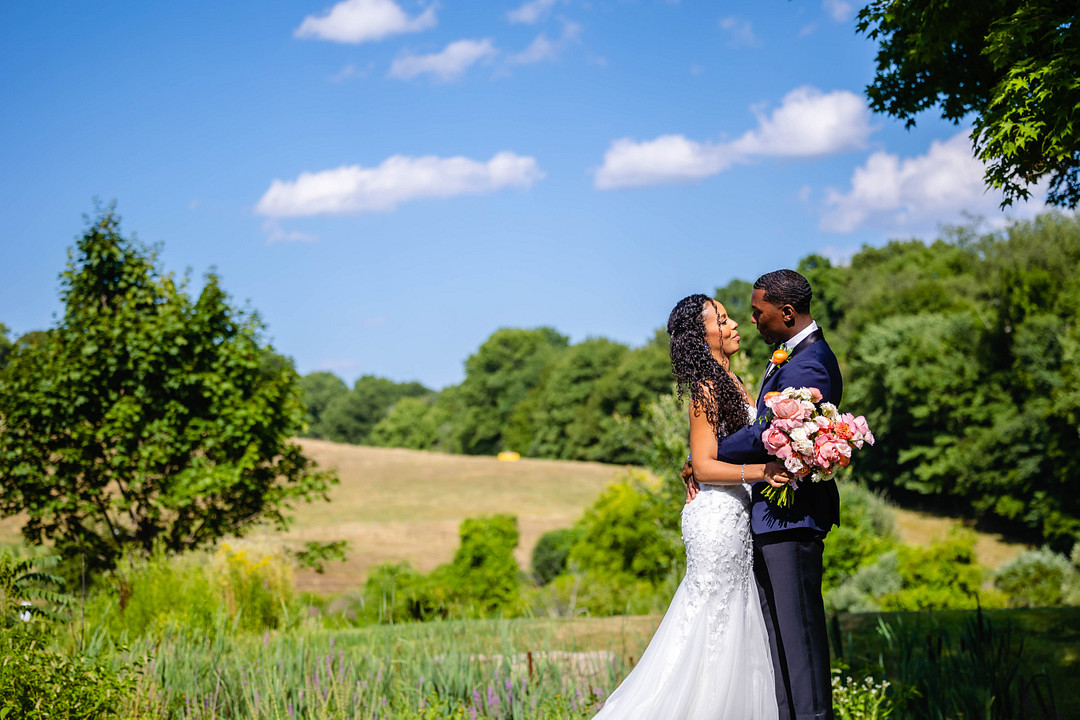 Green pastures, bright florals, a classic red barn, and two glam gowns are highlights of this chic barn wedding in Boston.