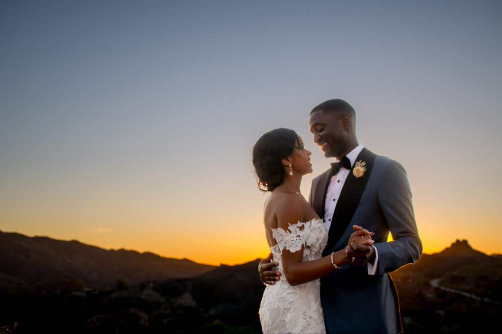 This hilltop vineyard wedding in Malibu is everything sweet with a sunset-inspired color story, an outdoor ceremony, and two glam dresses!