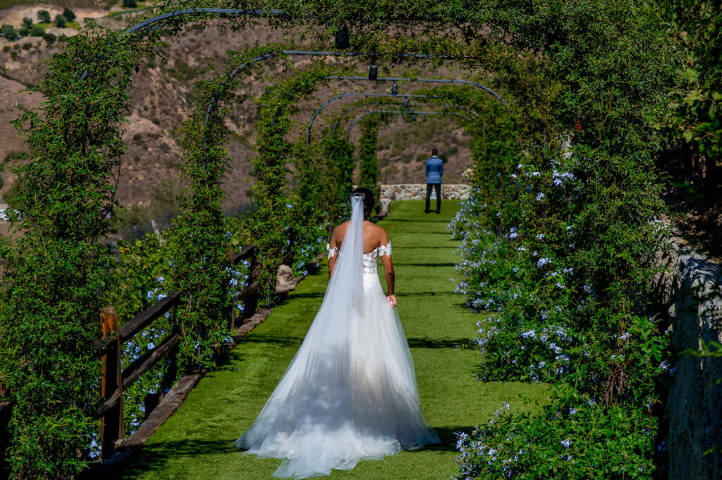 This hilltop vineyard wedding in Malibu is everything sweet with a sunset-inspired color story, an outdoor ceremony, and two glam dresses!