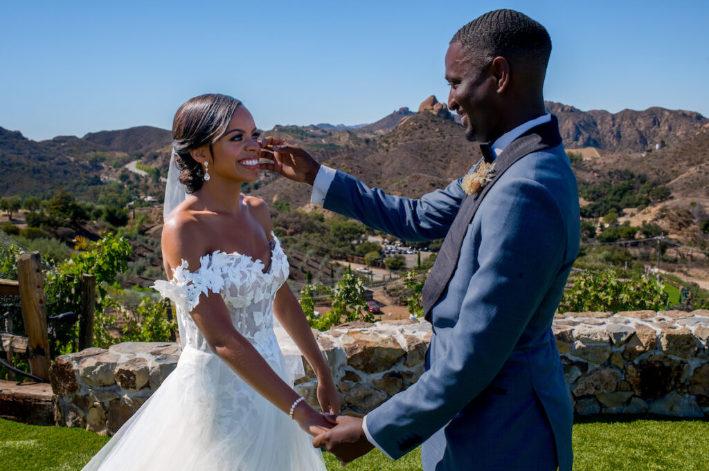 This hilltop vineyard wedding in Malibu is everything sweet with a sunset-inspired color story, an outdoor ceremony, and two glam dresses!