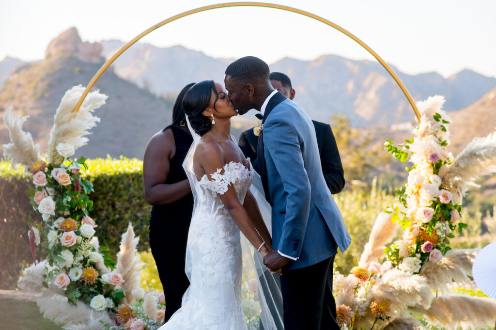 This hilltop vineyard wedding in Malibu is everything sweet with a sunset-inspired color story, an outdoor ceremony, and two glam dresses!