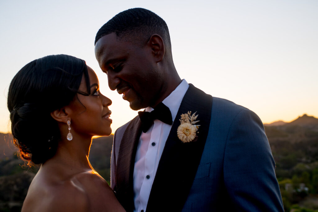 This hilltop vineyard wedding in Malibu is everything sweet with a sunset-inspired color story, an outdoor ceremony, and two glam dresses!