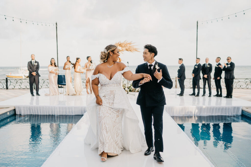 Beach waves and white sand welcomed guests to Alexis and Ronnie's summer outdoor destination wedding in Mexico.