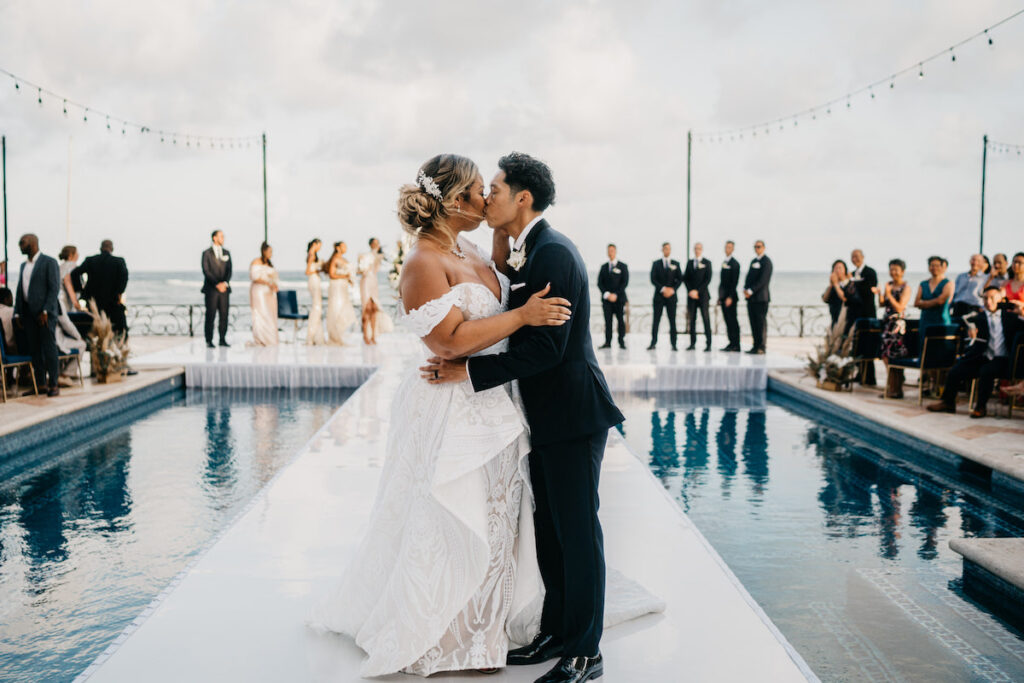 Beach waves and white sand welcomed guests to Alexis and Ronnie's summer outdoor destination wedding in Mexico.