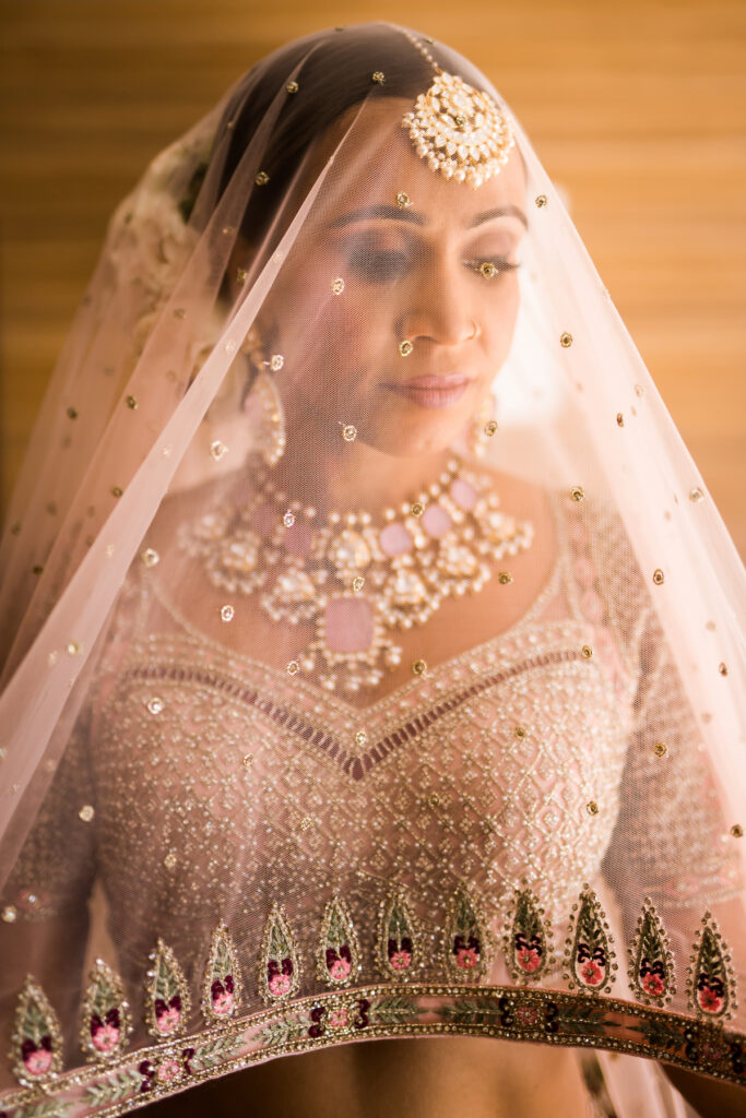 Indian nuptials features fuchsia florals, a sangeet pre-wedding party, and a stunning Hindu wedding ceremony at the New Orleans Museum of Art. 