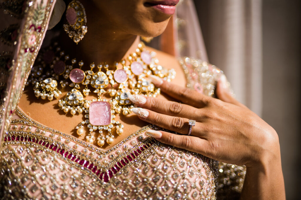 Indian nuptials features fuchsia florals, a sangeet pre-wedding party, and a stunning Hindu wedding ceremony at the New Orleans Museum of Art. 