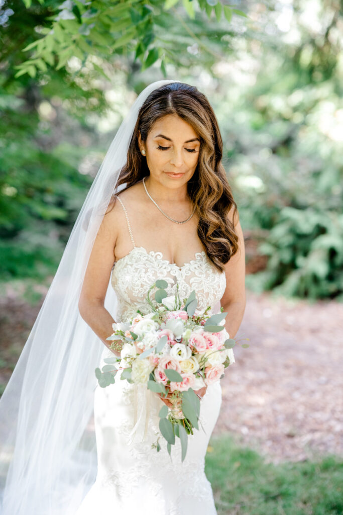 This waterfront wedding at the Tyee Yacht Club in Seattle, WA, features soft pink blooms, pops of red, and a bilingual English/Spanish ceremony.