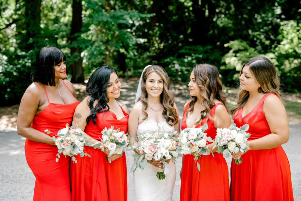 This waterfront wedding at the Tyee Yacht Club in Seattle, WA, features soft pink blooms, pops of red, and a bilingual English/Spanish ceremony.