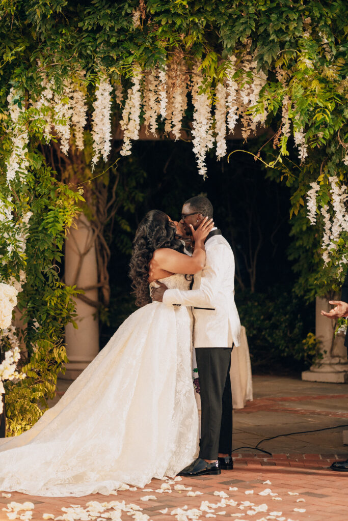 Arielle and Jamari's black-tie wedding affair featured romantic fashion with a dramatic flare and classic white and gold decor!