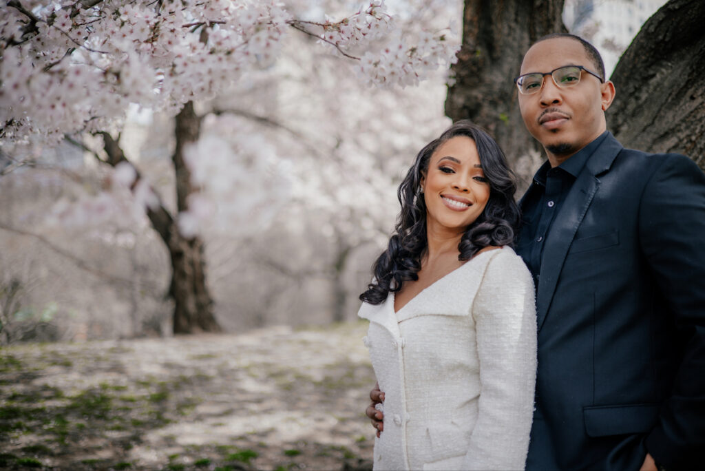 Morin and Caron's timeless spring e-session features elegant style, fully bloomed cherry blossoms, and the iconic scenery of Central Park!