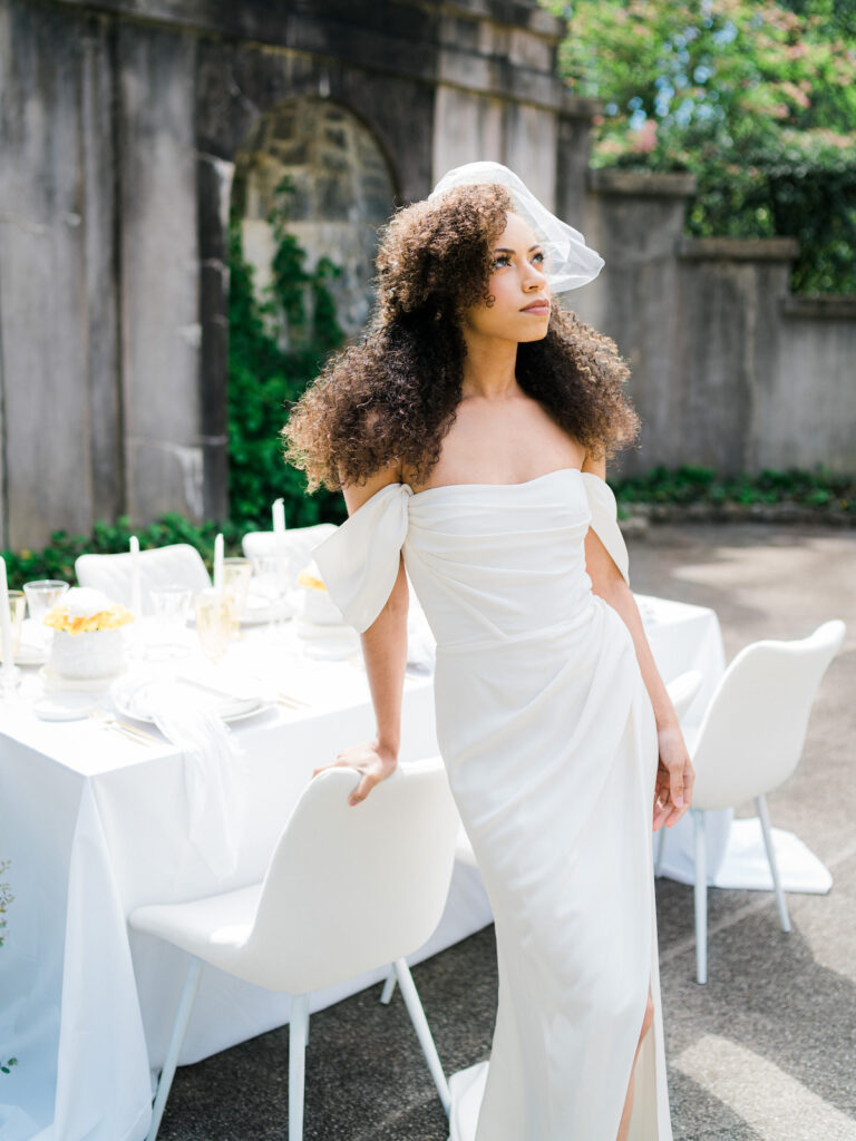 Inspired by the fresh feeling summer brings and the color yellow, this modern summer-styled shoot at the Swan House Atlanta History Center features a contemporary tablescape and decor with romantic touches and three fashion-forward bridal looks! 