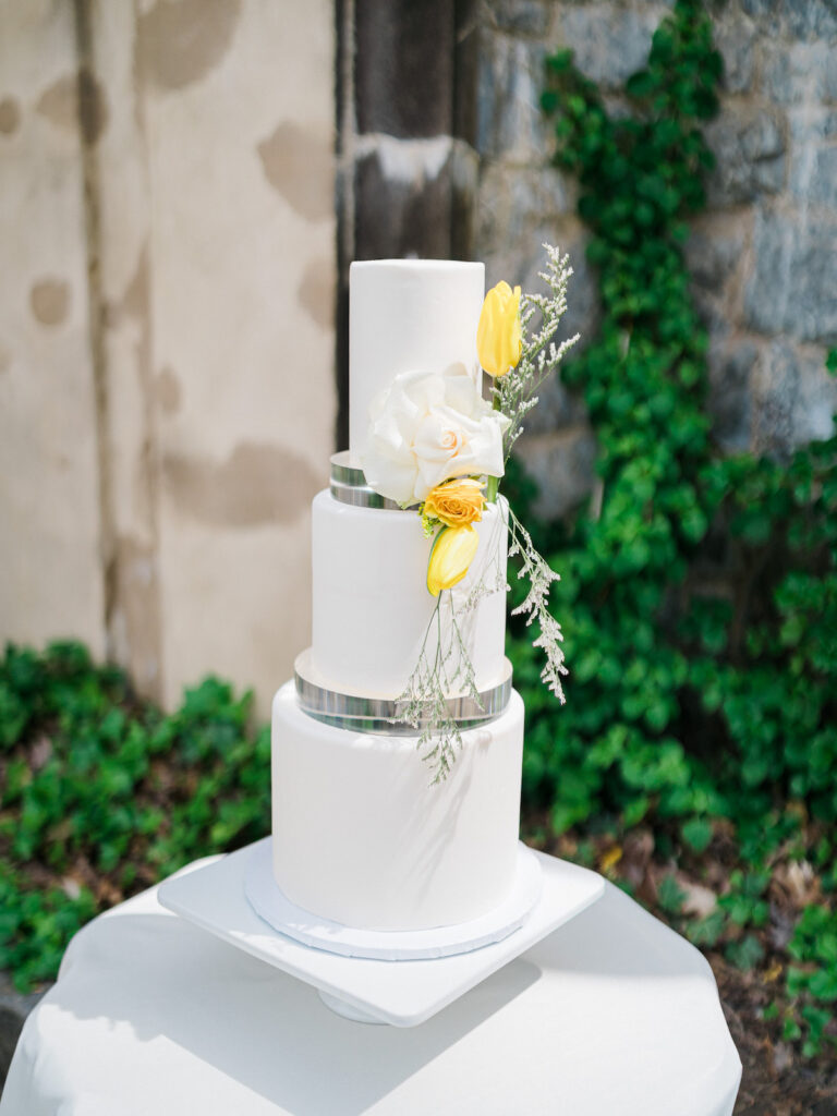 Inspired by the fresh feeling summer brings and the color yellow, this modern summer-styled shoot at the Swan House Atlanta History Center features a contemporary tablescape and decor with romantic touches and three fashion-forward bridal looks! 