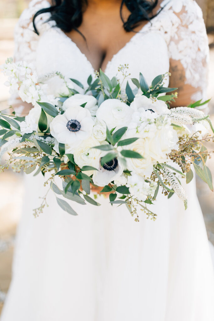 This wedding at Koury Farms in Georgia is perfect for the edgy boho bride with white flowers, greenery, and elevated gold accents.