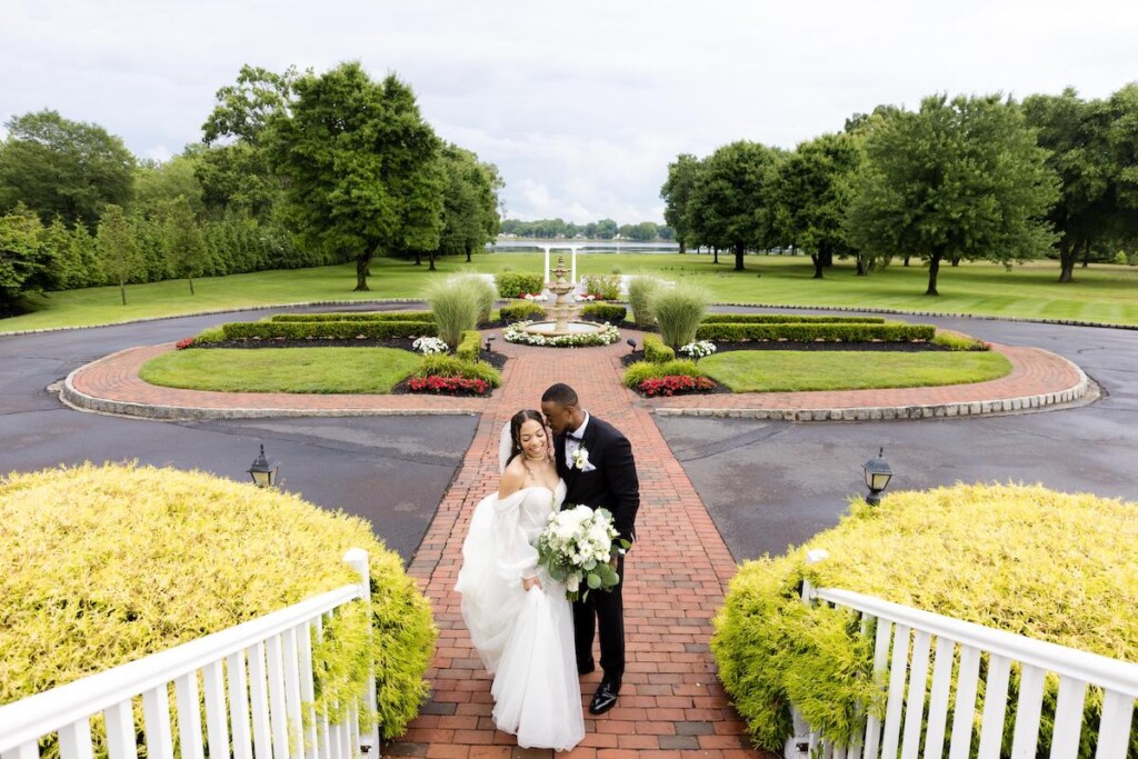 Haley and Jordan's elegant wedding at the Pen Ryn Mansion features lush greenery, personal details, and Jamaican cultural elements.