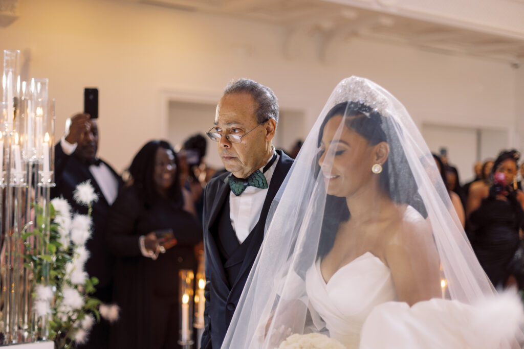 In this luxe ballroom wedding, fairytale details caught our eyes with romantic roses, tiaras, candles, and sparkly gowns.