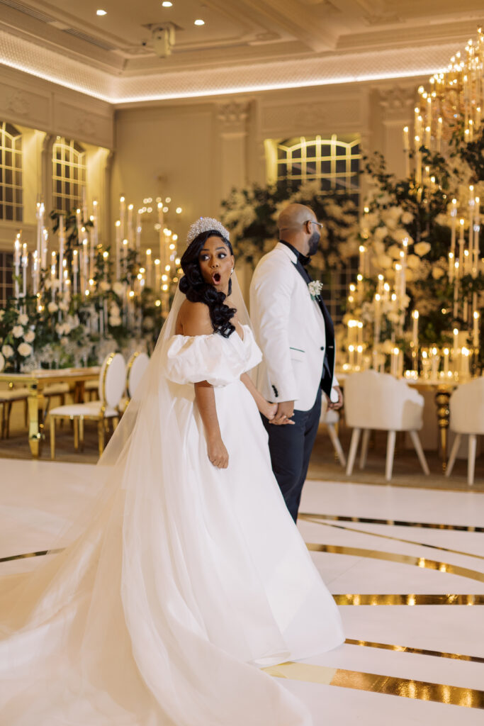 In this luxe ballroom wedding, fairytale details caught our eyes with romantic roses, tiaras, candles, and sparkly gowns.