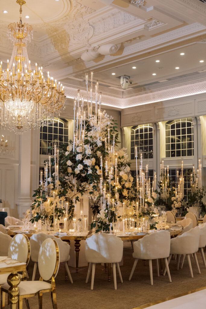 In this luxe ballroom wedding, fairytale details caught our eyes with romantic roses, tiaras, candles, and sparkly gowns.