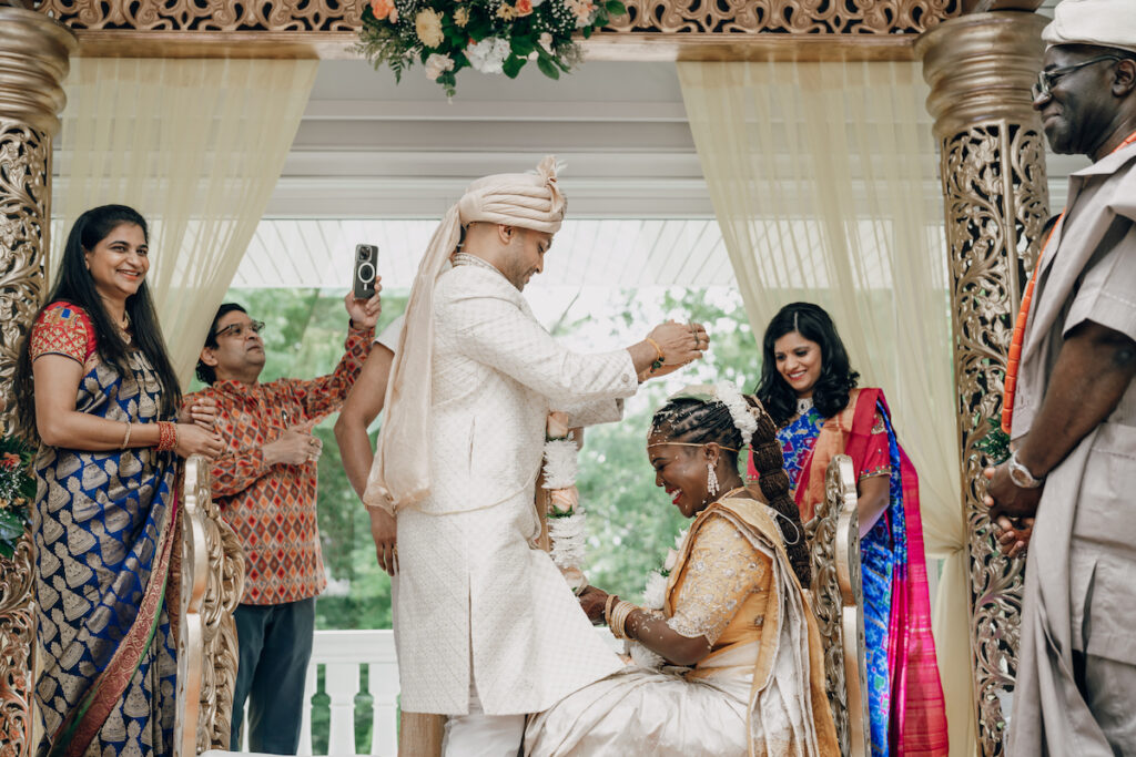 Bunmi and Kiran wed at their vibrant multicultural wedding which beautifully blended traditional Hindu and Nigerian wedding customs!