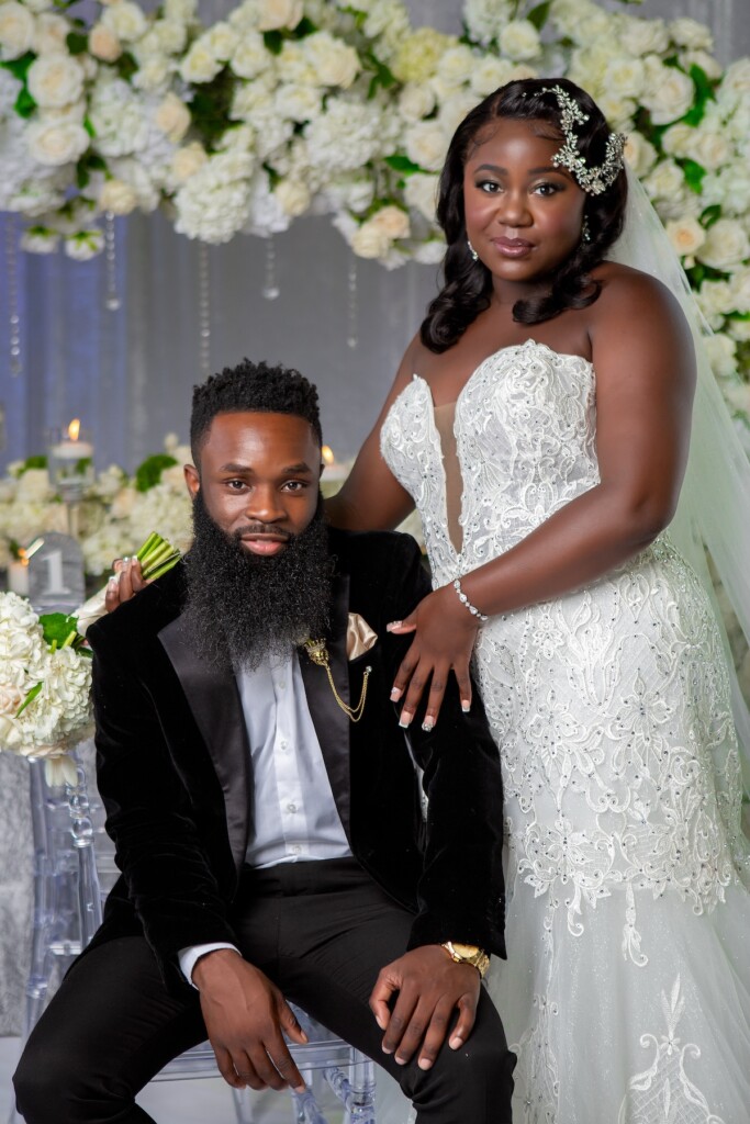 Contemporary Black love-styled shoot at Hosted By Hodlen in Philadelphia features gold and silver hues and white floral details.