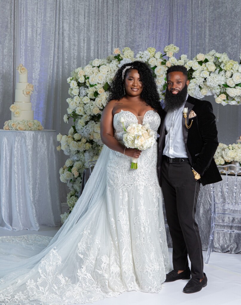 Contemporary Black love-styled shoot at Hosted By Hodlen in Philadelphia features gold and silver hues and white floral details.