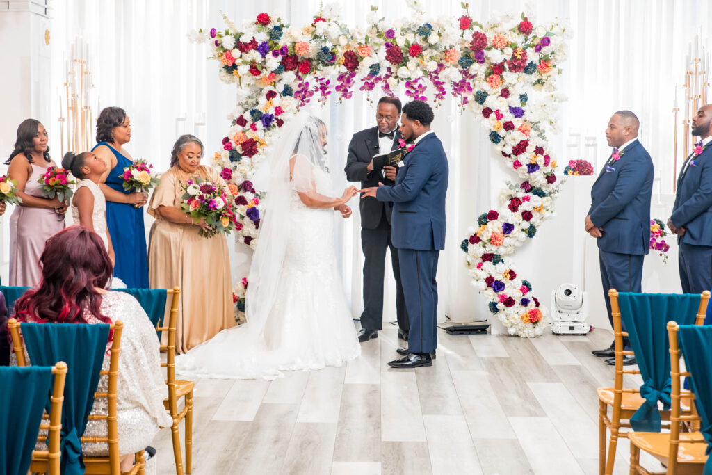 Vibrant jewel-toned colors and fun entertainment (including a caricaturist) made this ballroom wedding in South Carolina one of a kind.