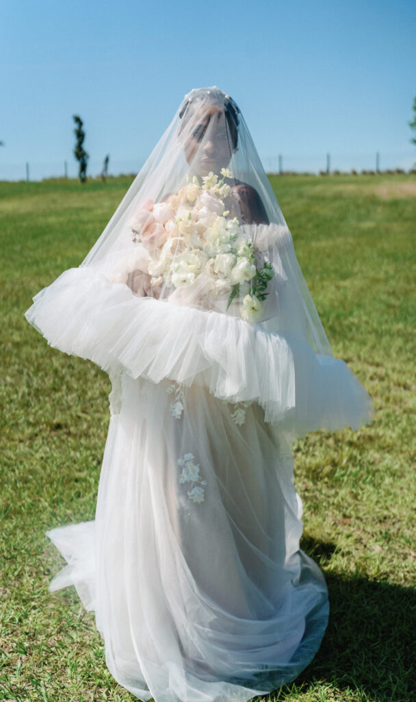 This playful sun-filled styled wedding shoot in Florida features gorgeous florals, pretty pearls, and royal honey hues.