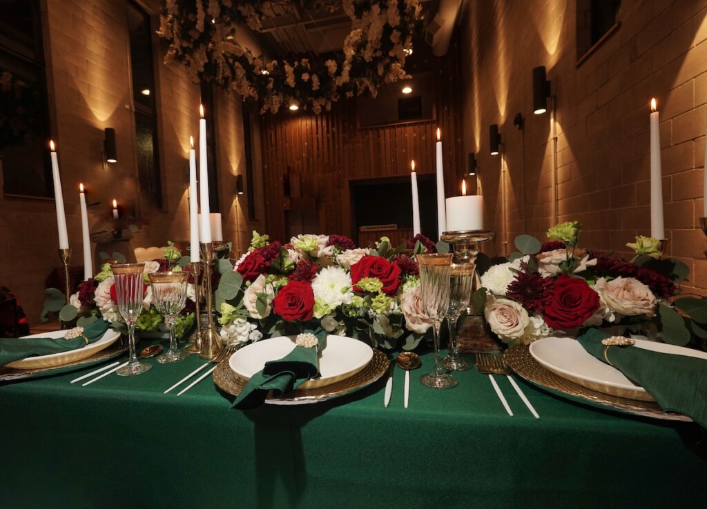 L Prestigious Events LLC crafted a breathtaking winter tablescape with emerald green hues, opulent gold accents, and romantic candles. (Featuring florals by fellow coterie member HTTS Floral and Event Design!).