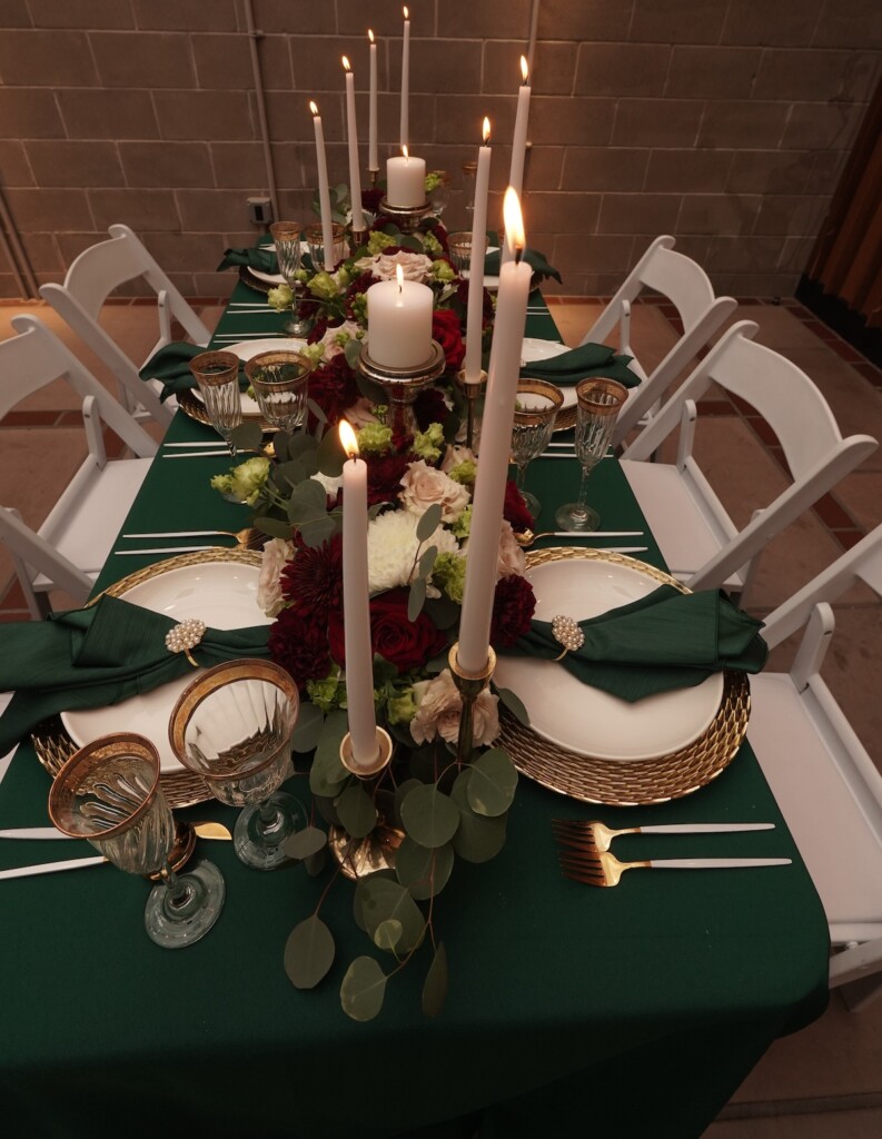 L Prestigious Events LLC crafted a breathtaking winter tablescape with emerald green hues, opulent gold accents, and romantic candles. (Featuring florals by fellow coterie member HTTS Floral and Event Design!).